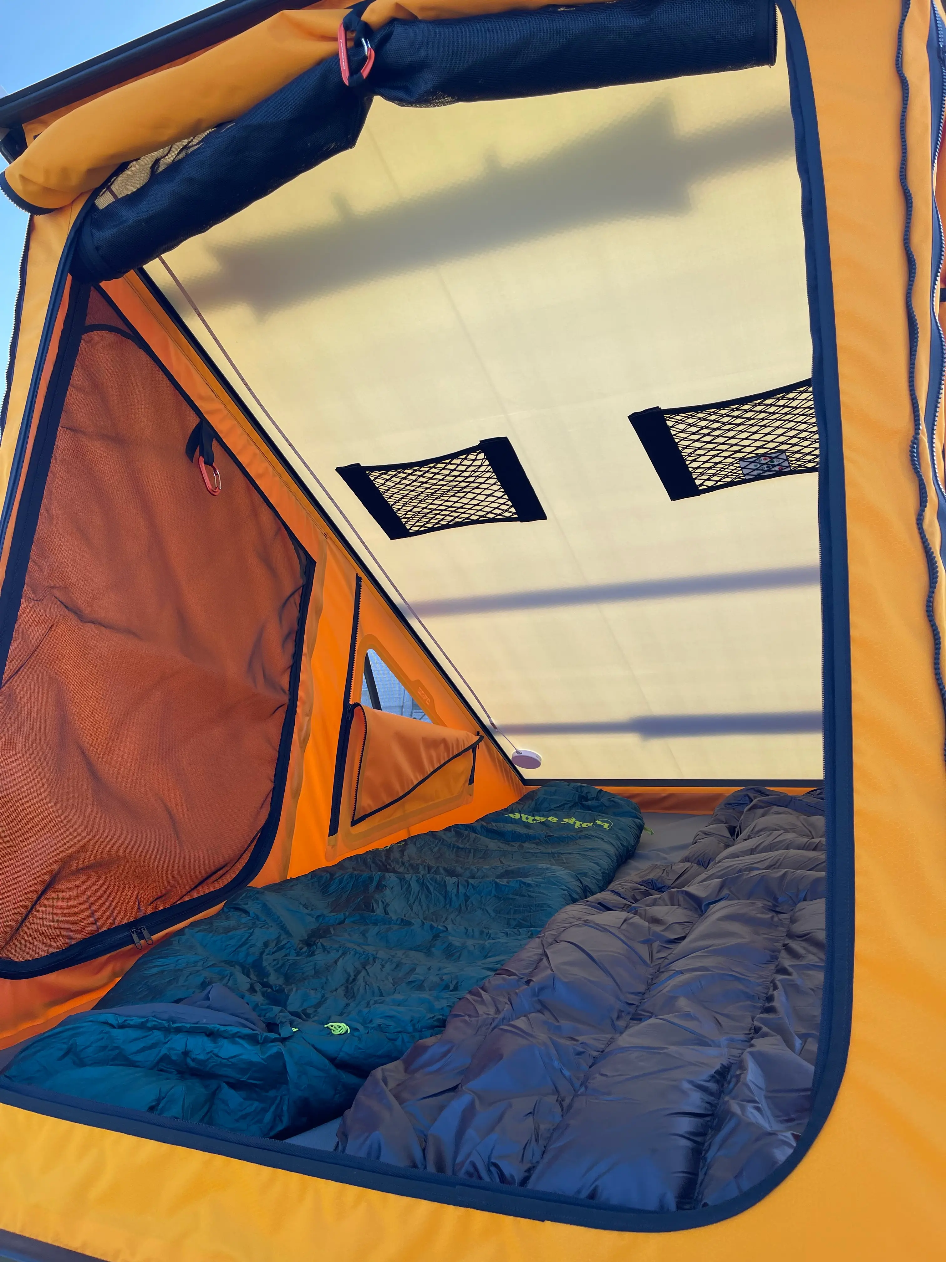 Inside the Go Fast Camper pop-up tent with sleeping bags laid out