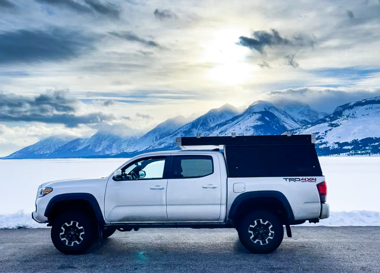 Toyota Tacoma TRD Off-Road with the Go Fast Camper closed, low-profile drive configuration