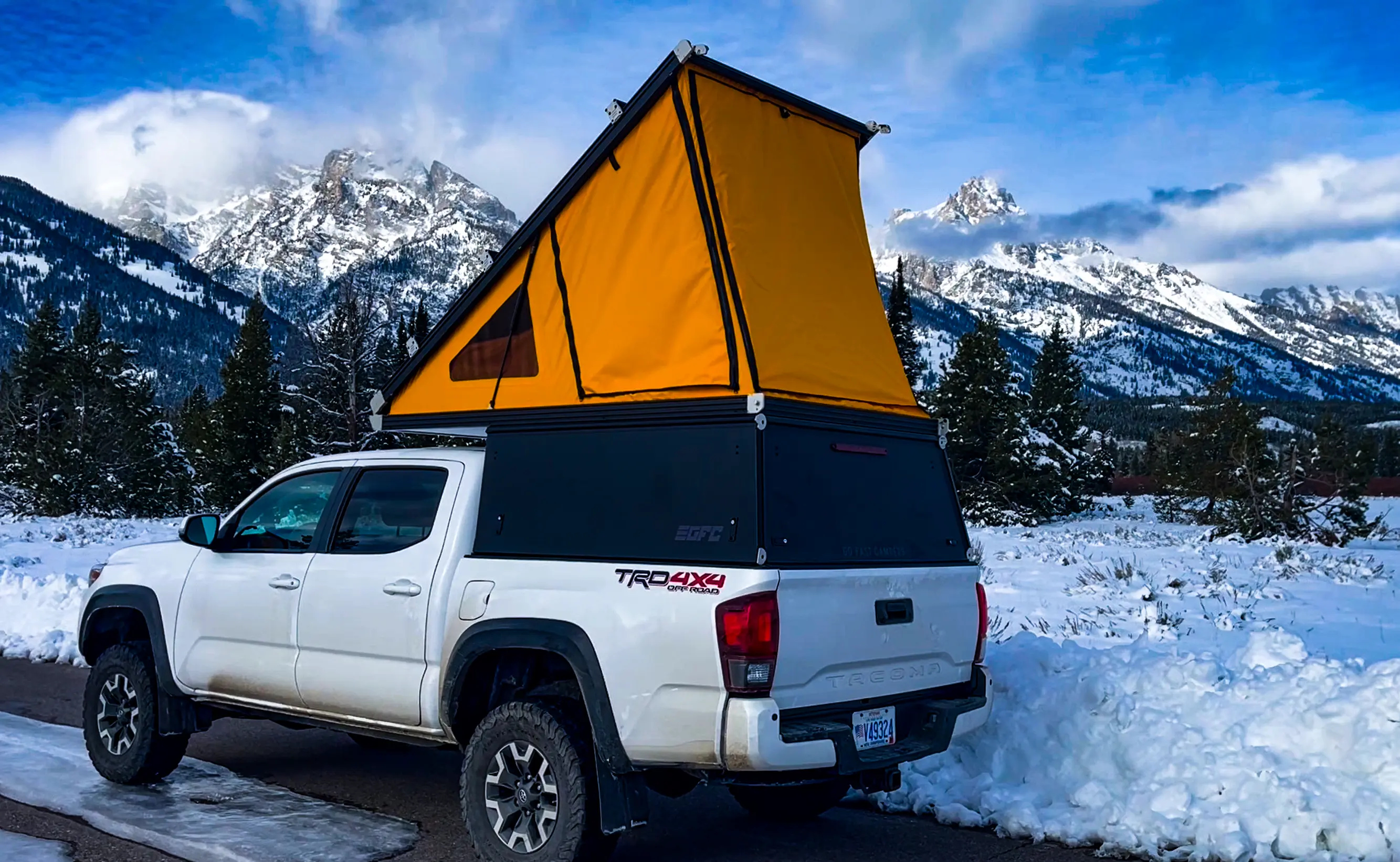 Rear three-quarter view of the Tacoma with the Go Fast Camper open